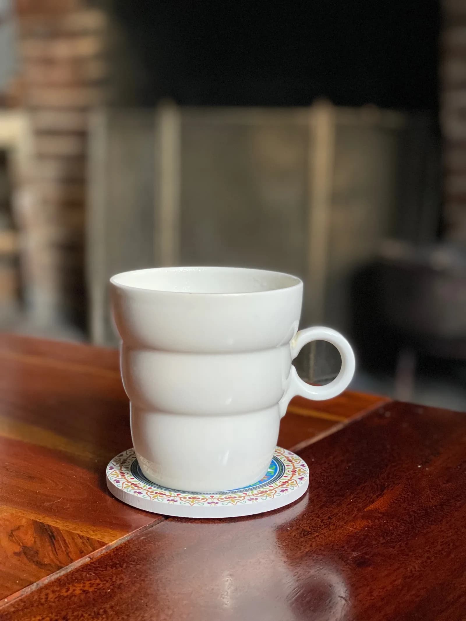 Une tasse de thé posée sur une table en bois, près de la cheminée